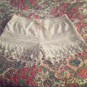 Cream colored crochet shorts .